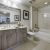 well lit bathroom with shower/tub combo