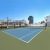 gated, outdoor tennis court on rooftop