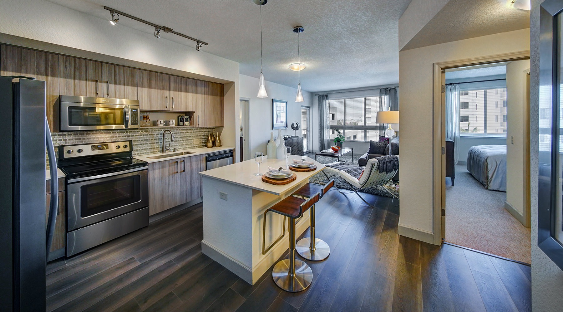 Welcome to Loftin Place! Open concept living room and kitchen at Loftin Place luxury apartments in West Palm Beach